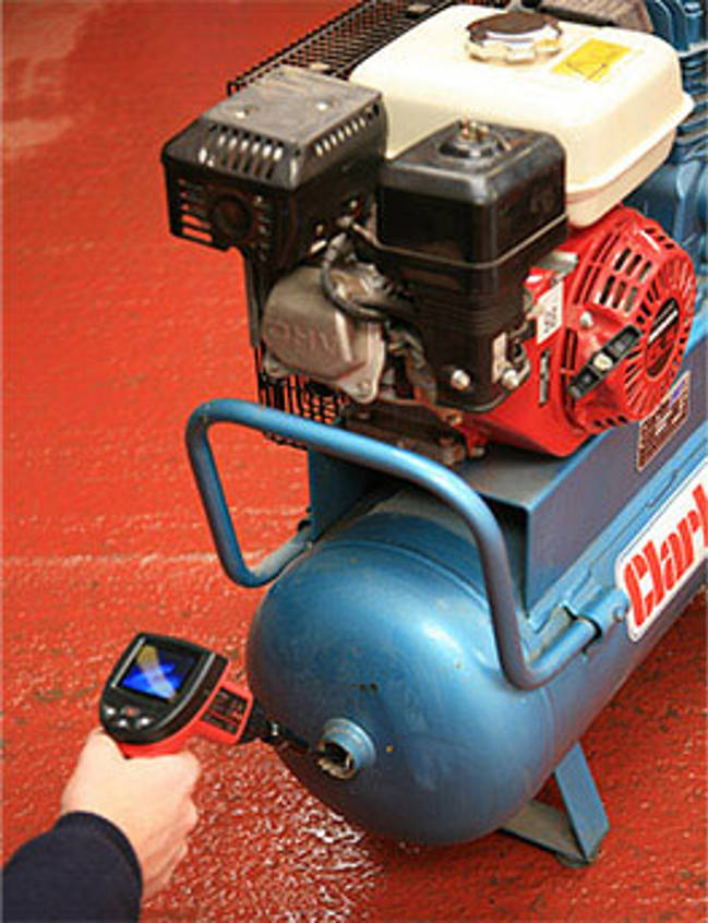 Inspecor holding a red testing device next to a small pressure system.
