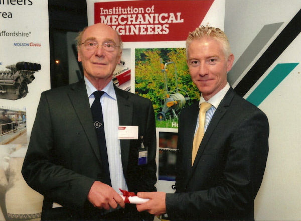 Bill Manning, ISI Engineer surveyor receiving a certificate at an award ceremony.