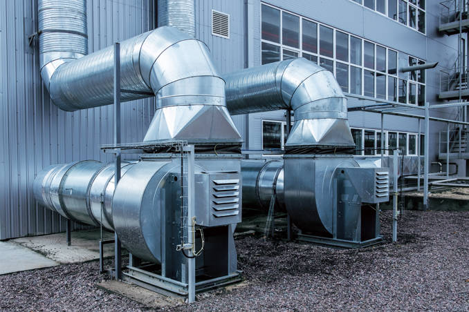 Two large ventilation systems on the exterior of an industrial plant.